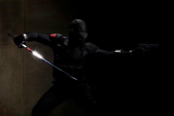 A ninja in a black suit and a sword in his hand is preparing for battle