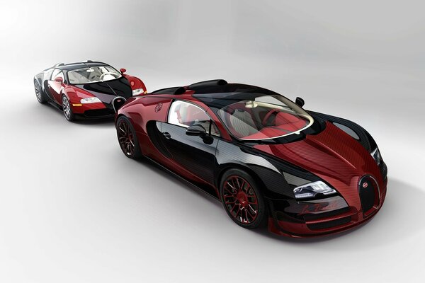 Dos coches deportivos Bugatti Veyron negro y rojo