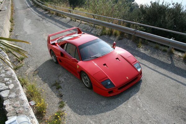 Red Ferrari sports car on the rise on the serpentine