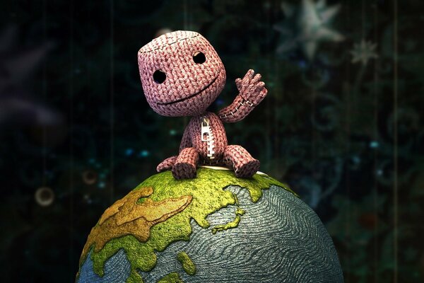 A knitted man who sits on a knitted planet