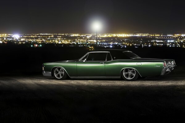 Voiture lincoln continental dans la nuit en dehors de la ville