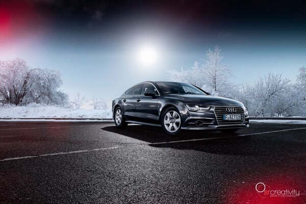 Audi a7 car on the background of snowy trees