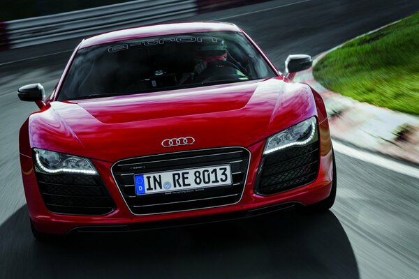 Front view of a red Audi in motion at speed