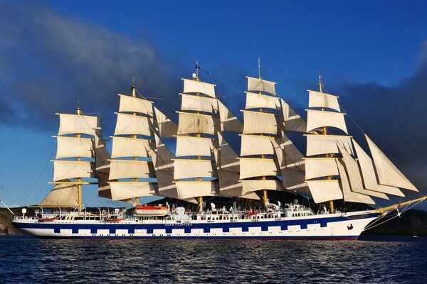 Royal clipper sailboat on the moon of the sky and shore