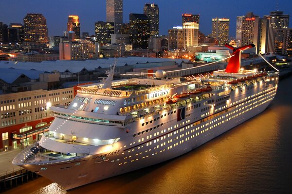 Cruise ship at the pier near the city