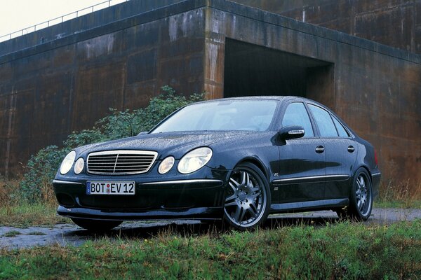 Mercedes-benz sur fond de garages et d herbe