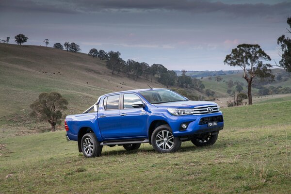 Blue car in hilly terrain