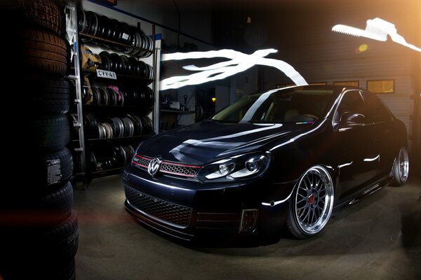 Black volkswagen jetta indoors with tires