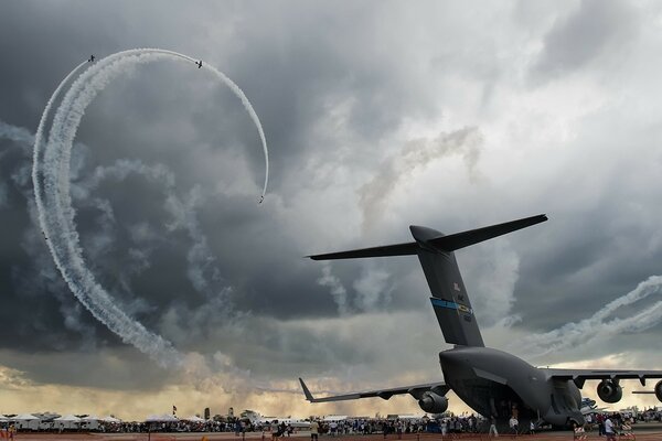 A spiral of planes against a dark cloud