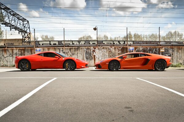 Orange Lamborghini and Ferrari stand face to face