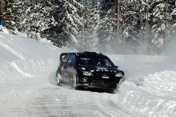 A black Ford car on a snowy road