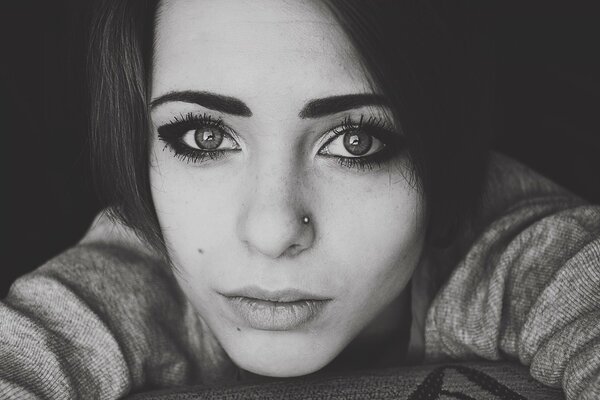 Black and white photo of a girl with a nose piercing