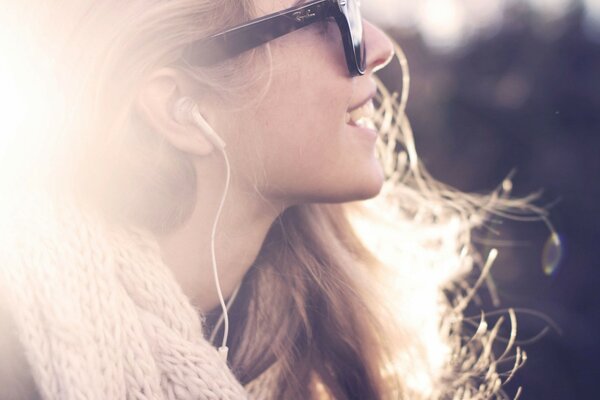 Blonde girl listens to music