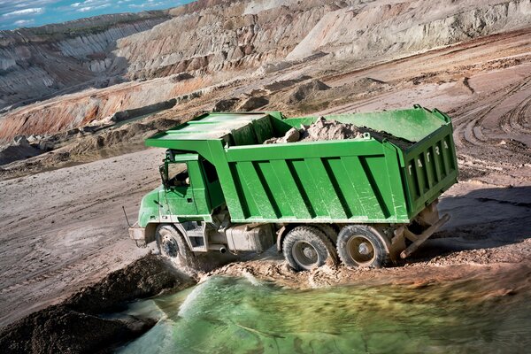 Green truck with sand at the quarry