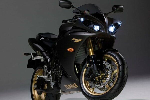 Black Yamaha bike on a gray background