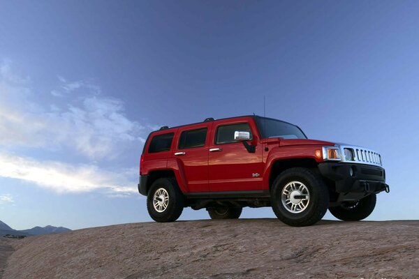 Militant hummer h3 on top of a cliff