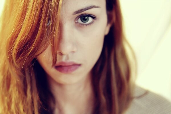 Red-haired girl with beautiful big eyes