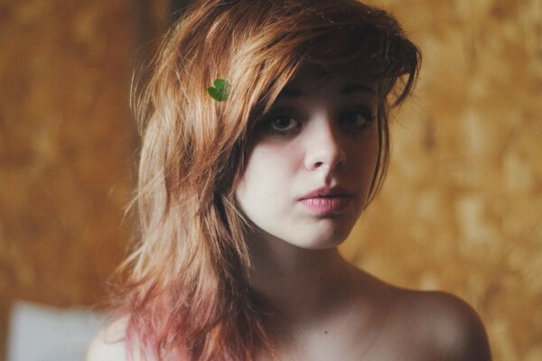 Red-haired girl on a golden background