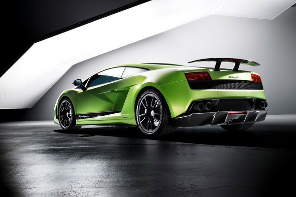 Green sports car in the parking lot rear view