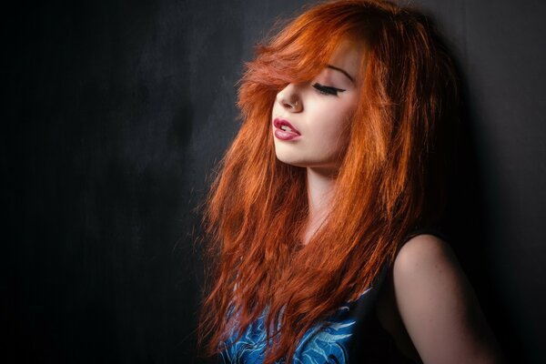 Red-haired beauty at the black wall