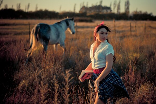 A girl and a horse on the field