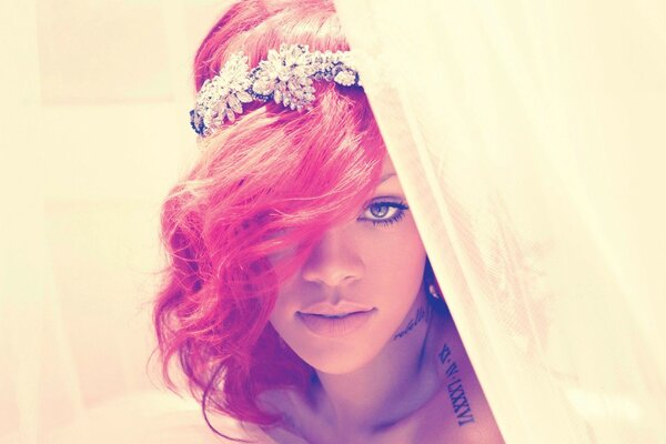 Singer Rihanna with pink hair with a beautiful tiara in her hair behind the curtains