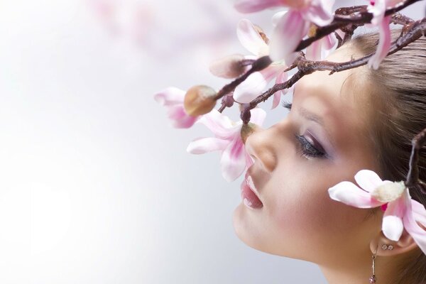 Photo of a beautiful woman with a flowering tree