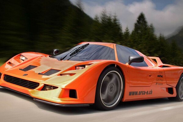 Orange car orca c113 is driving at full speed