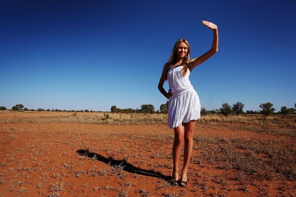 Model girl covers the sun with her hand