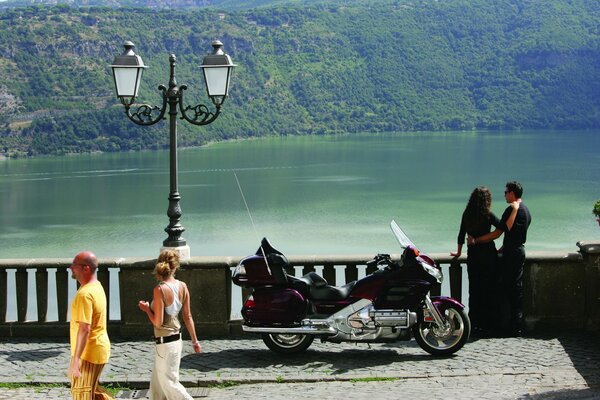 Paar mit Motorrad an der Stadtpromenade