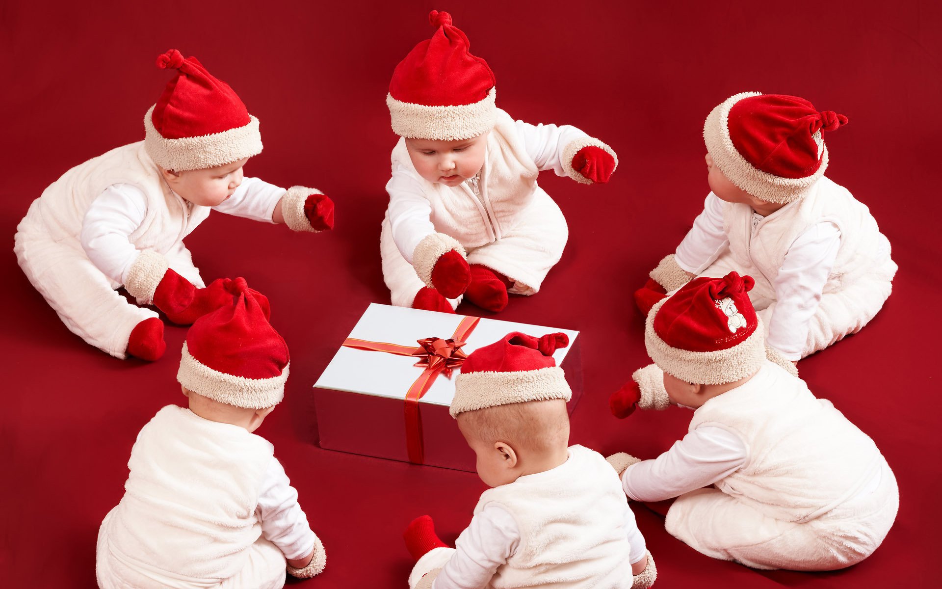 six enfants cadeau vacances nouvel an fond rouge costumes chapeaux enfants tout-petits santaclausy vacances