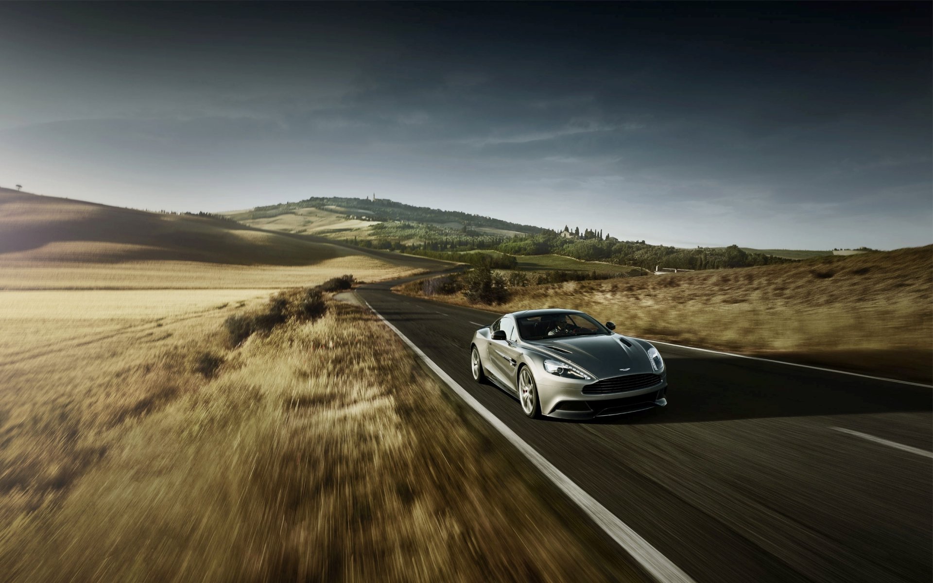 aston martin am310 vanquish machine suite in motion road front