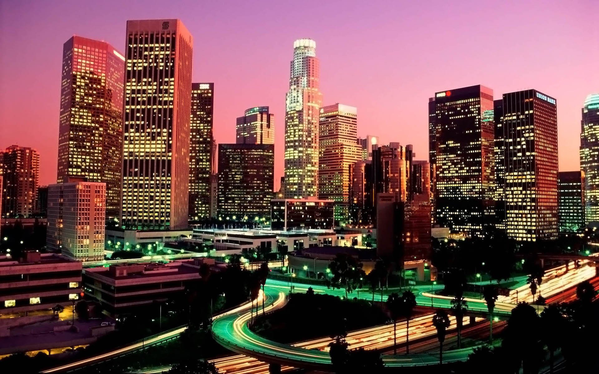 panorama city buildings pink sky evening sunset skyscrapers metropolis lights lanterns highway road light in windows city lights view house