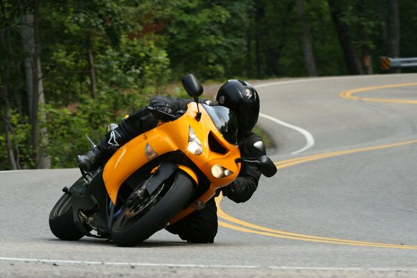 A man hurriedly rides a motorcycle