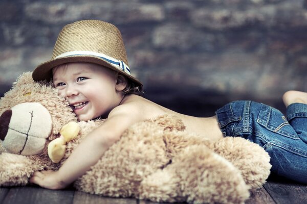 A child hugs a teddy bear