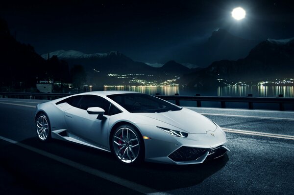 On the night road under the moon - white lamborghini