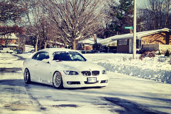 Snow-covered landscape and on the road - a white boomer in a small drift