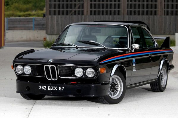 The car is a black BMW C with a red and blue stripe