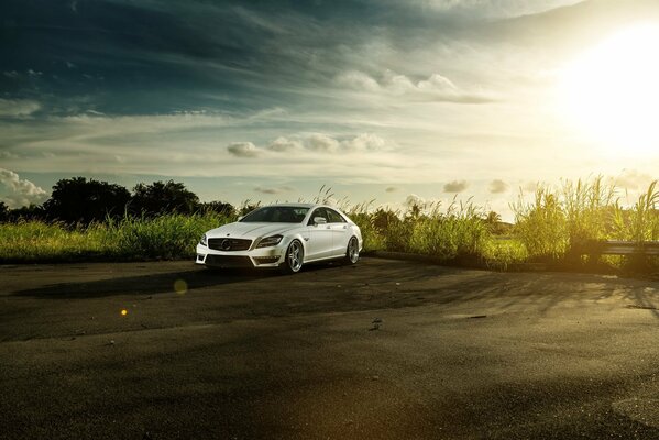 White Mercedes Benz CLS class more equipped compared to the E class