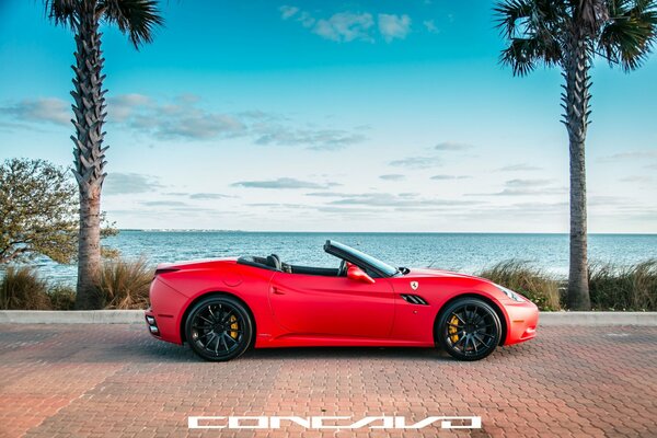 California. Matte red Ferrari convertible with side