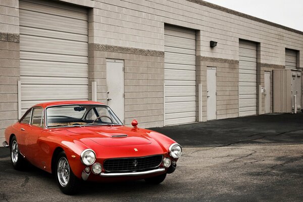 Red ferrari gt retro near the garage