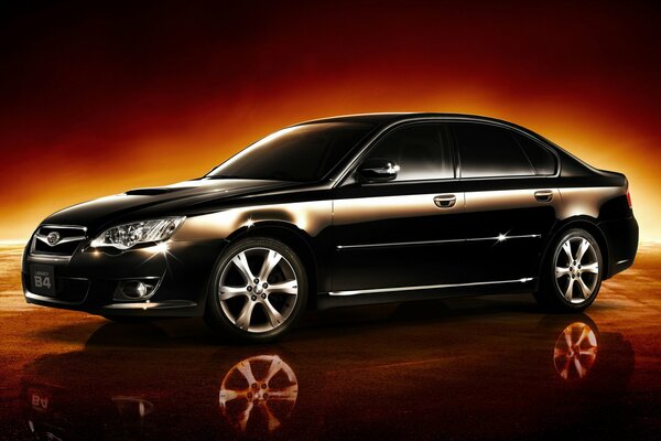 On a fiery black background - a black Subaru sports sedan