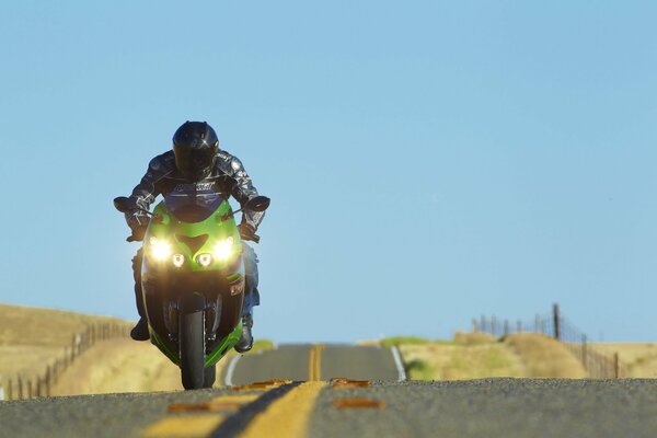 Green motorcycle on a straight road