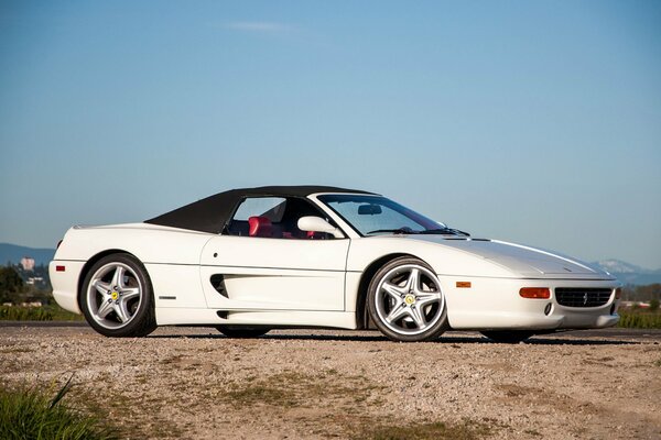 White expensive Ferrari on asphalt