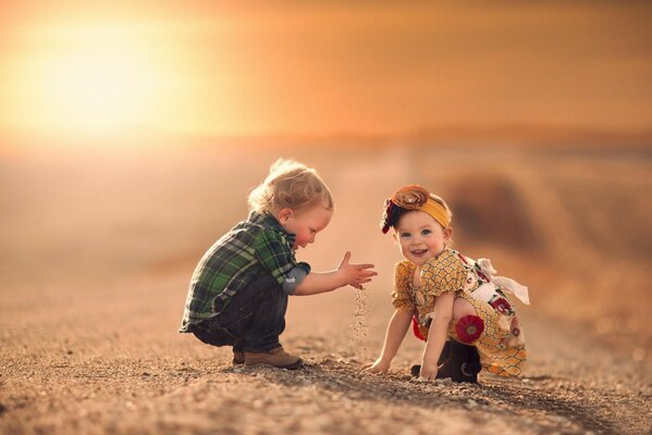 A boy and a girl are sitting on the road