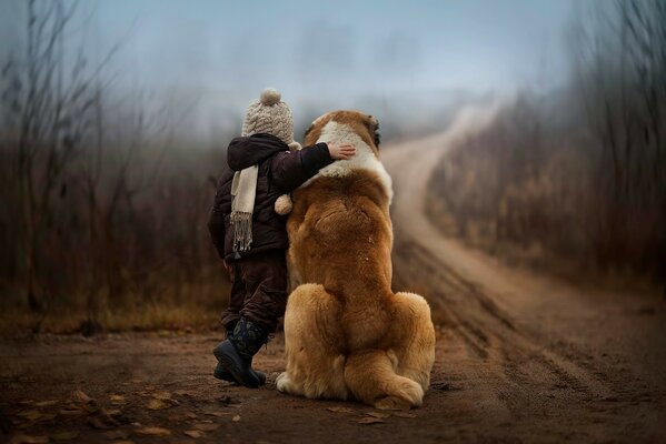 A child hugs his best friend the dog