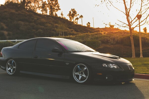 Black tuning Pontiac GTO sunset position