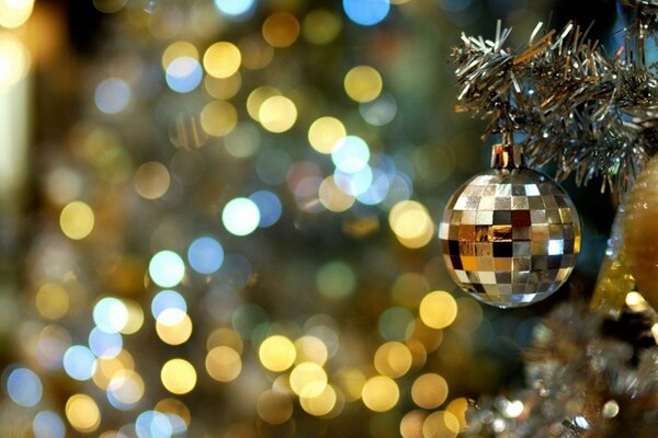 Festive balloon on the branch of the Christmas tree