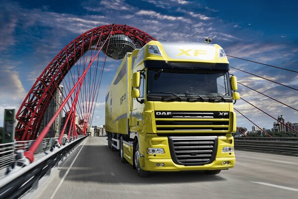 A large lemon-colored tractor on the bridge