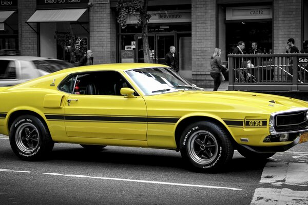 Amarillo clásico Ford Mustang en la carretera